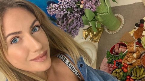 Яскрава квітка: Леся Нікітюк в total black прикрила пікантне декольте букетом півоній