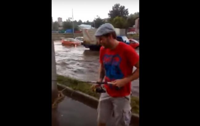 Незвичайна риболовля: чоловік упіймав рибу на затопленій вулиці дощем