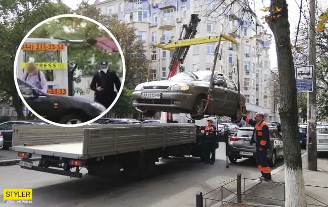 В Киеве "героиня парковки" залезла на эвакуатор и отбивалась от полиции (видео)