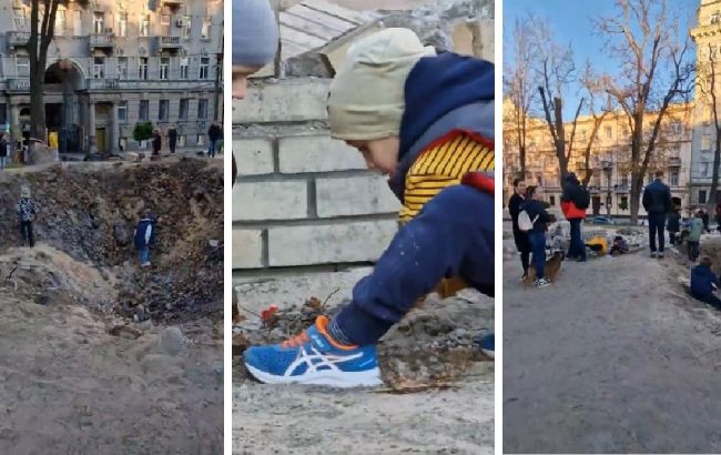 В центрі Києва діти влаштували "ігровий майданчик" у вирві від російської ракети (відео)